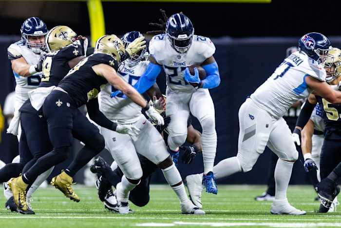 Tennessee Titans running back Derrick Henry (22) leaps over the New Orleans Saints defensive line during the first half at the Caesars Superdome.